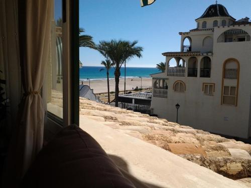 a view of the beach from a window of a building at Al Andalus, Playa de Muchavista in El Campello