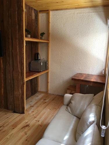 a living room with a couch and a table at Hostal Plaza Chiloe in Castro