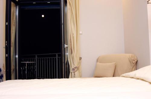 a bedroom with a bed and a window at Frini Studios in Plomarion