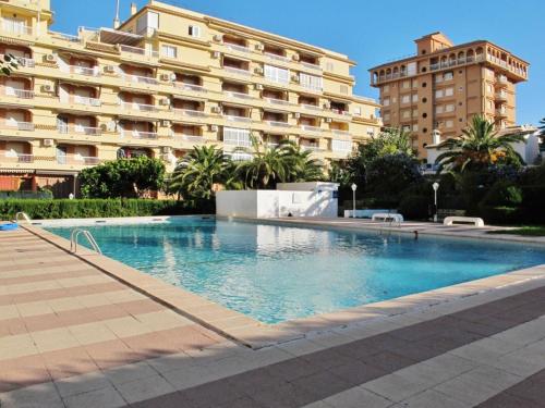 a swimming pool in front of a large building at Playa Gandia, Iris, piscina AA y WiFi in Gandía