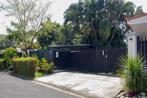 a black fence in front of a house at Terida Airport B&B in Alajuela City