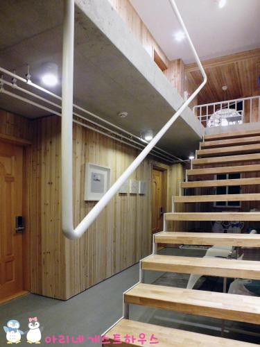 a staircase in a room with wooden walls and wooden stairs sidx sidx sidx at Ariene Guesthouse in Gwangju
