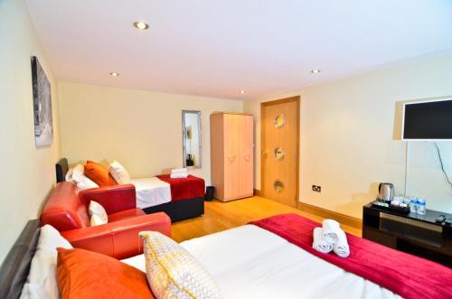 a hotel room with two beds and a television at Thames View House Surrey Quays in London