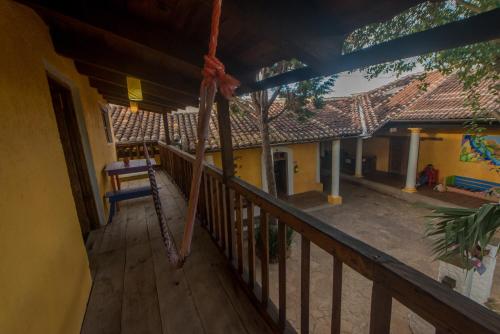 a porch of a house with a swing at Rossco Hostel & Hotel in San Cristóbal de Las Casas