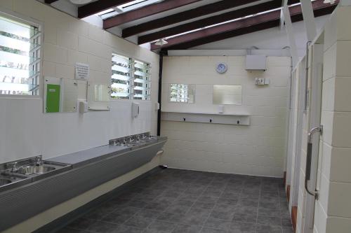 a bathroom with sinks and mirrors in a room at Geraldine TOP 10 Holiday Park in Geraldine