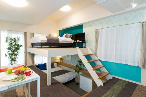 a small room with a bunk bed and a desk at The Metropolitan in Fukuoka