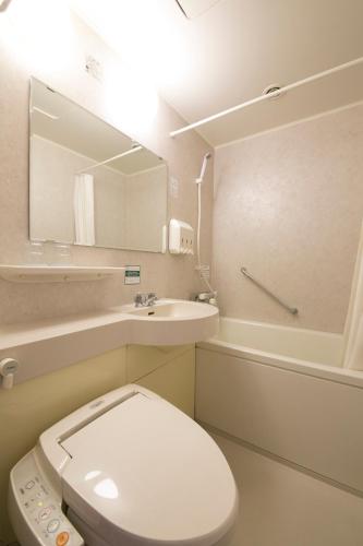a bathroom with a toilet and a sink and a mirror at Nara Washington Hotel Plaza in Nara