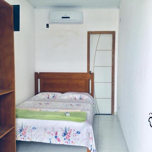 a small bedroom with a bed and a ladder at Pousada Amazonas in Itabuna