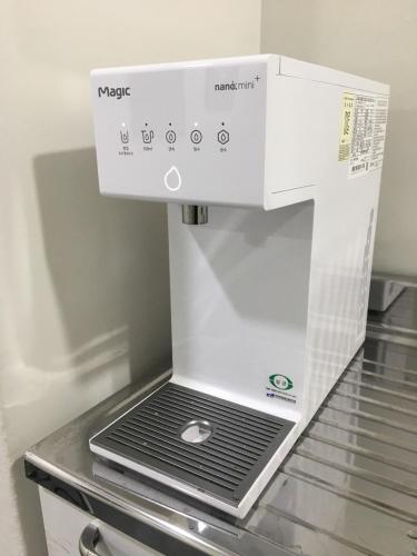 a white coffee maker sitting on top of a refrigerator at Neat House in Seoul