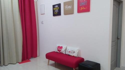 a red bench in a room with red curtains at MaiHomestay Seri Iskandar in Seri Iskandar