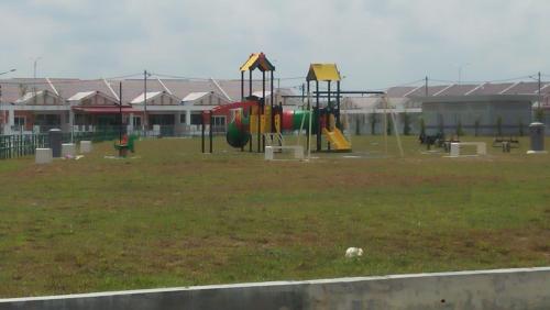 a park with a playground with slides and swings at MaiHomestay Seri Iskandar in Seri Iskandar