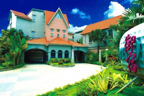 a large house with an orange roof and a driveway at Royal Group Motel Ming Chen Branch in Kaohsiung