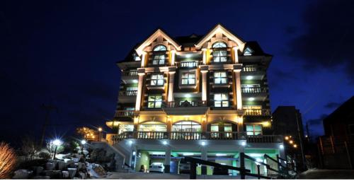 a large building with lights on it at night at Pension Badawa in Gangneung