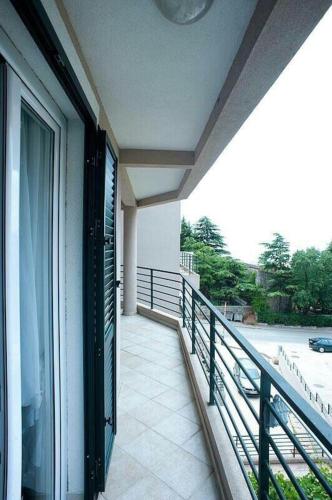 a balcony of a house with a view of the street at Maestral Apartment in Petrovac in Petrovac na Moru