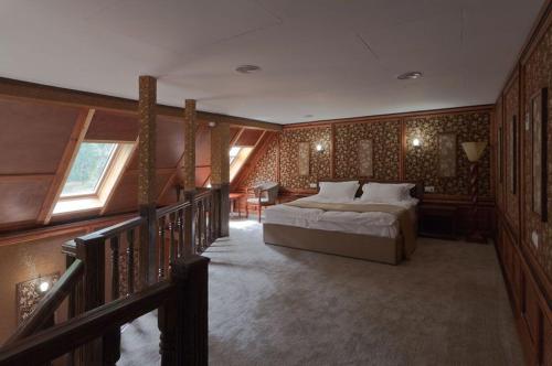 a bedroom with a bed in a room with windows at Hotel Alsey Krasnoyarsk in Sliznevo