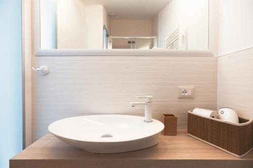 a bathroom with a white sink and a mirror at BED IN BO Porta San Mamolo in Bologna