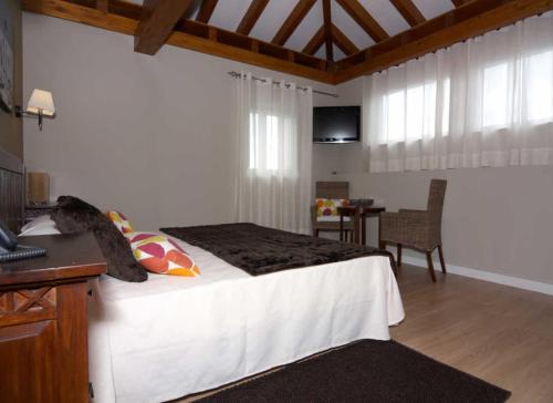 Ένα ή περισσότερα κρεβάτια σε δωμάτιο στο Hospedería el Puerto