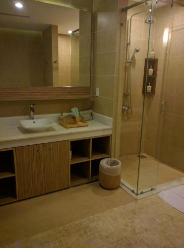 a bathroom with a sink and a shower at The Cliff Residence in Mui Ne