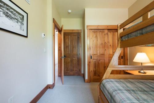 a bedroom with a bunk bed and a doorway at Cabins 21 in Old Mammoth