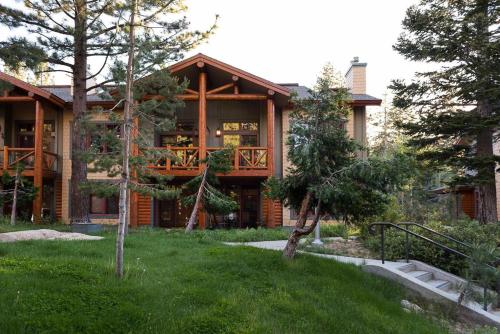 a log home with a porch and a deck at Cabins 13 in Old Mammoth
