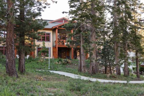 a house in the woods with trees at Cabins 21 in Old Mammoth