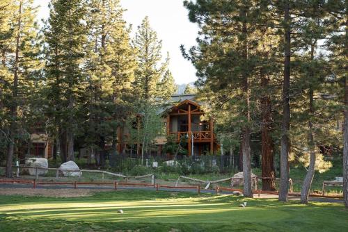 a golf course with a house in the background at Cabins 13 in Old Mammoth