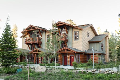 a large wooden house with a balcony at Cabins 21 in Old Mammoth