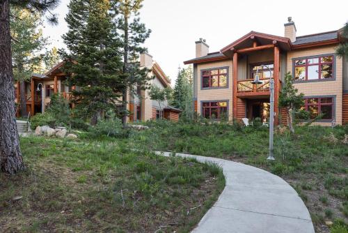 a house with a sidewalk in front of it at Cabins 13 in Old Mammoth