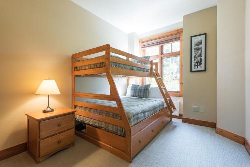 a bedroom with two bunk beds and a lamp at Cabins 21 in Old Mammoth