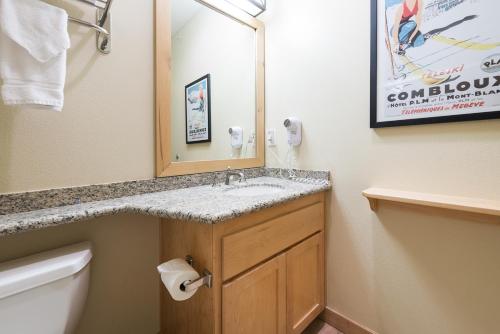 a bathroom with a sink and a mirror and a toilet at Sunstone 325 in Old Mammoth