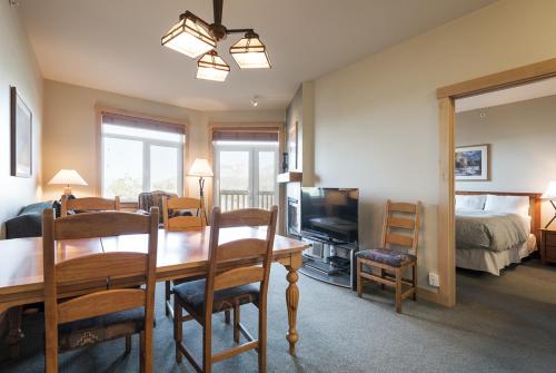 a living room with a dining room table and a bedroom at Sunstone 325 in Old Mammoth