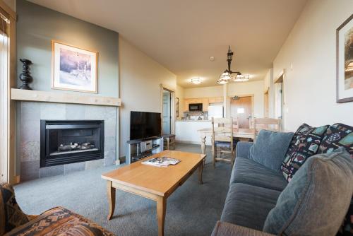 a living room with a couch and a fireplace at Sunstone 325 in Old Mammoth