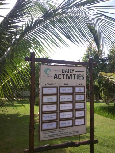 a sign for daily activities in a park at The Cliff Residence in Mui Ne