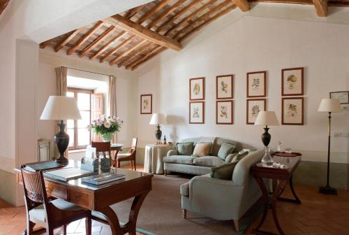 a living room with a couch and a table at Castello Banfi - Il Borgo - Relais et Chateaux in Montalcino