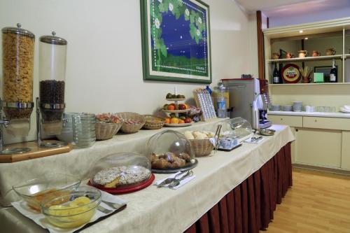 a kitchen counter with a bunch of food on it at Hotel Cristallo Brescia in Brescia