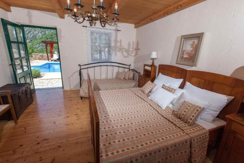 a bedroom with a bed and a chandelier at Villa Oliva Bribir in Bribir