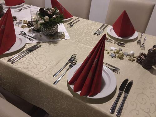 a table with red napkins and red hats on it at Hotel-Restaurant Tüxen in Rendsburg