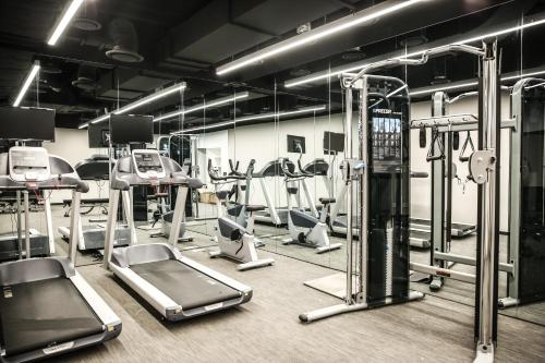 a gym with several treadmills and elliptical machines at GLAD Gangnam COEX Center in Seoul