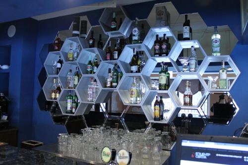 a display of bottles of alcohol on a wall at Non-stop hotel in Boryspilʼ