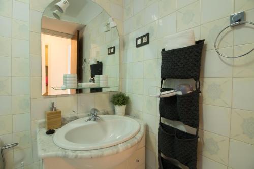 une salle de bains avec un lavabo et un miroir dans l'établissement Apartamento Faro 77, à Torrox Costa