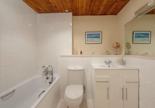 uma casa de banho com um WC, uma banheira e um lavatório. em The Hart Residence em Edimburgo