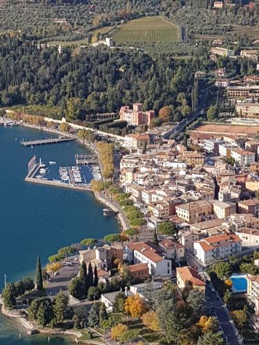 an aerial view of a town next to a body of water at Rooftop Apartment in Garda