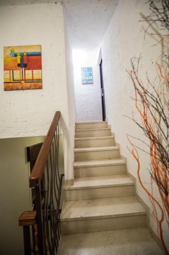a staircase in a building with a painting on the wall at Rooftop Apartment in Garda
