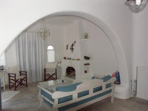 a living room with a bed and a fireplace at Karades Houses Poseidon 75m2 in Naxos Chora