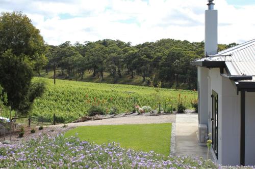 a house with a garden and a field of flowers at Esto house in Crafers