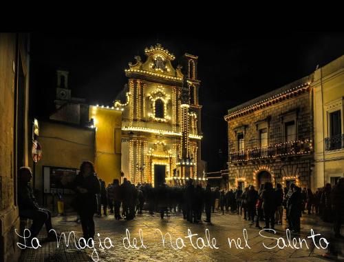 a group of people walking down a street at night at Casa vacanze spiaggia dorata in Marina di Pescoluse