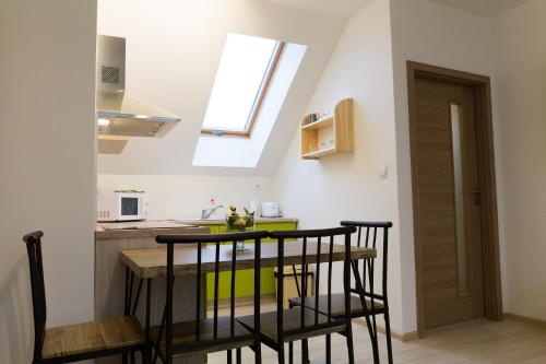 a kitchen with a table and chairs in a room at Apartmány pre Vás in Levice