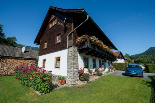 a house with flowers on the side of it at Ferienhaus Nickl in Weissbriach