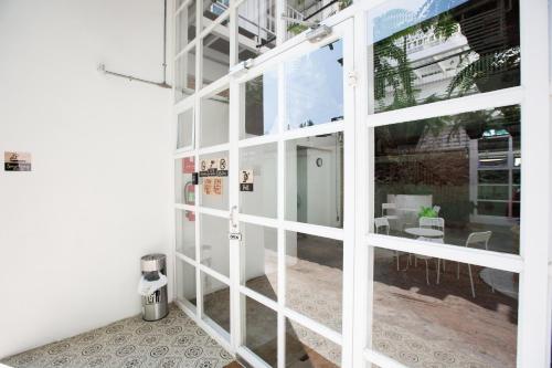 a glass door in a room with a patio at Memmoth Hostel In Lampang in Lampang