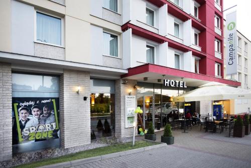 a hotel with a sign in the window of it at Campanile Lublin in Lublin